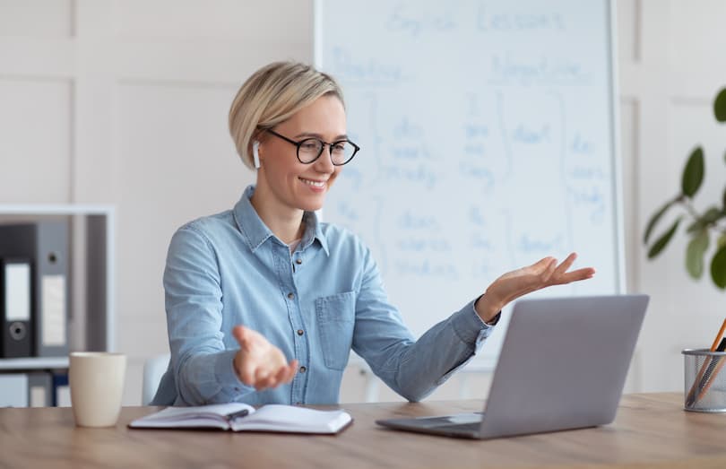 Une femme enseigne en ligne derrière un ordinateur portable