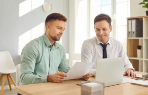 Two men smile becuse of their Accounting Software.